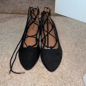 Black flats with lace up around ankle. Never worn